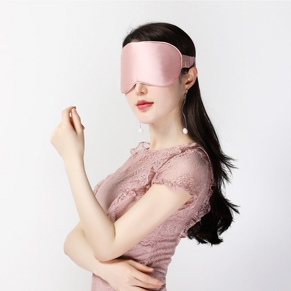 E10 Graphene Heated Silk Eye Mask: pink mask side wearing view.