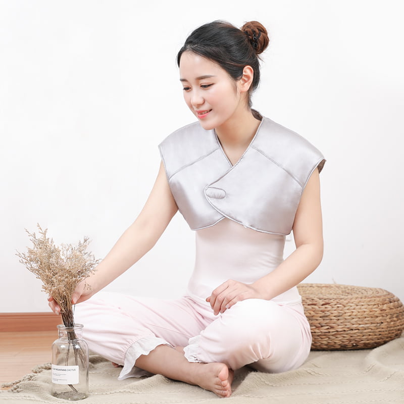 T10 Graphene Heated Silk Shoulder Neck Pad: woman wearing the gray wrap while seated.