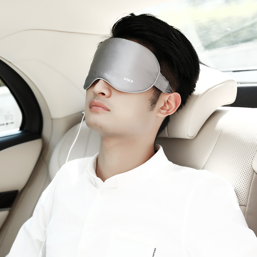 E10 Graphene Heated Silk Eye Mask: man wearing the gray mask in a car.