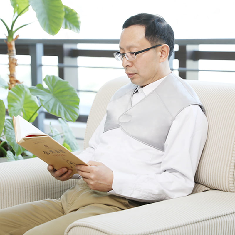 T10 Graphene Heated Silk Shoulder Neck Pad: man wearing the gray wrap while reading.