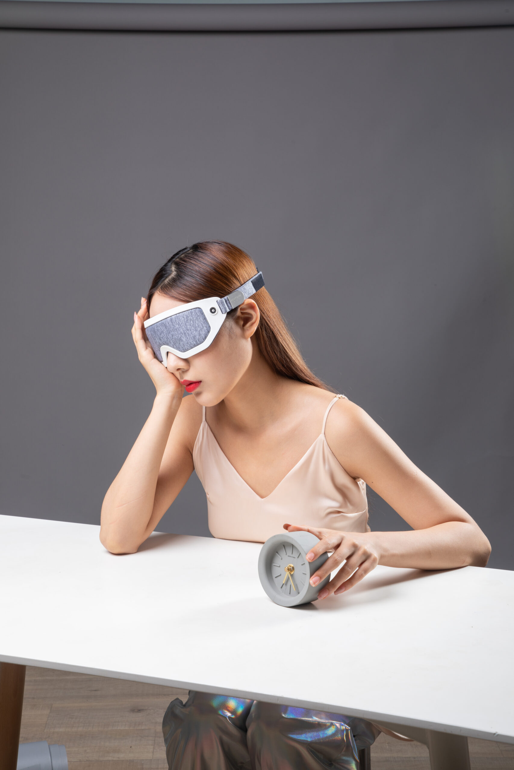 F30 Graphene Heated Sleep Eye Mask: woman wearing the mask at a table.