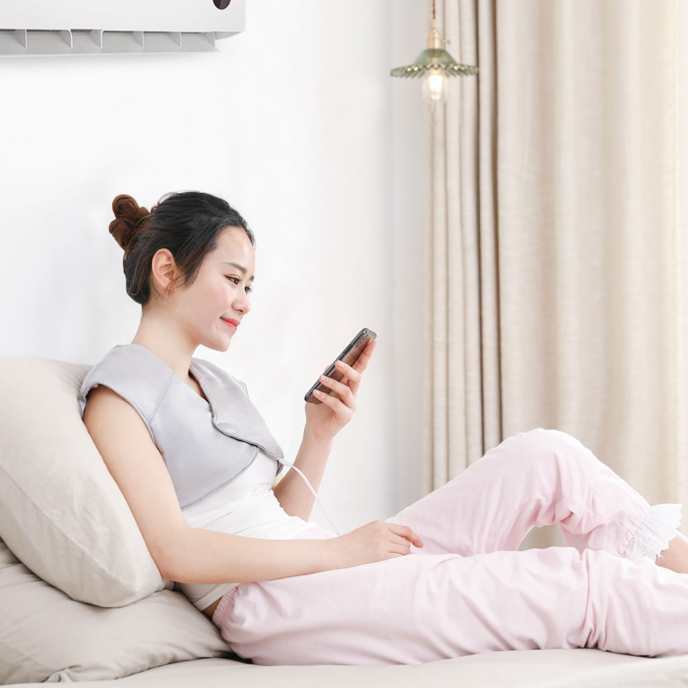 T10 Graphene Heated Silk Shoulder Neck Pad: woman resting in bed with the wrap.