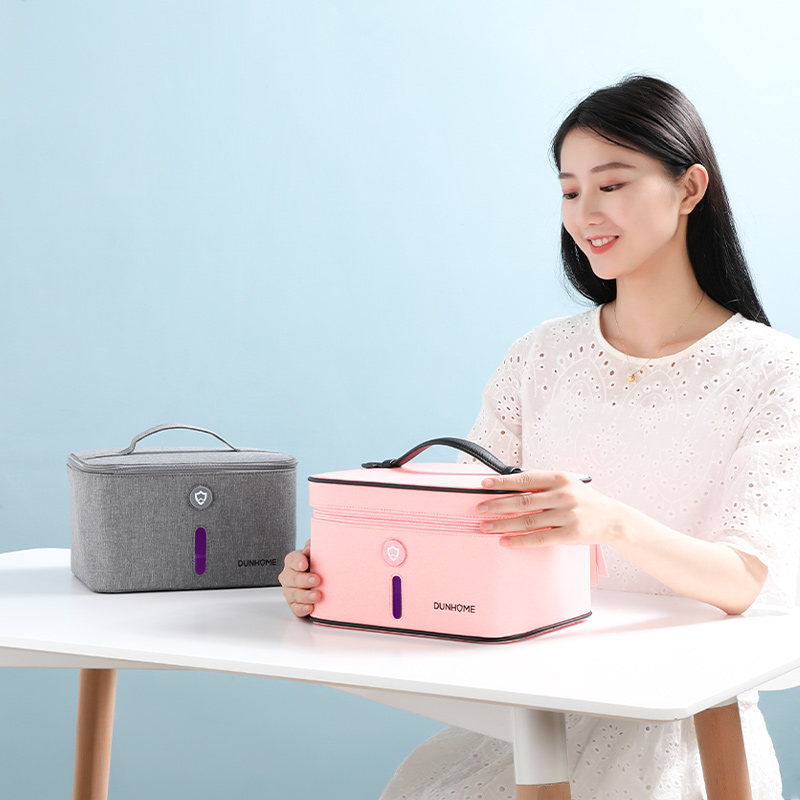 Pink UV disinfection box opened on a tabletop