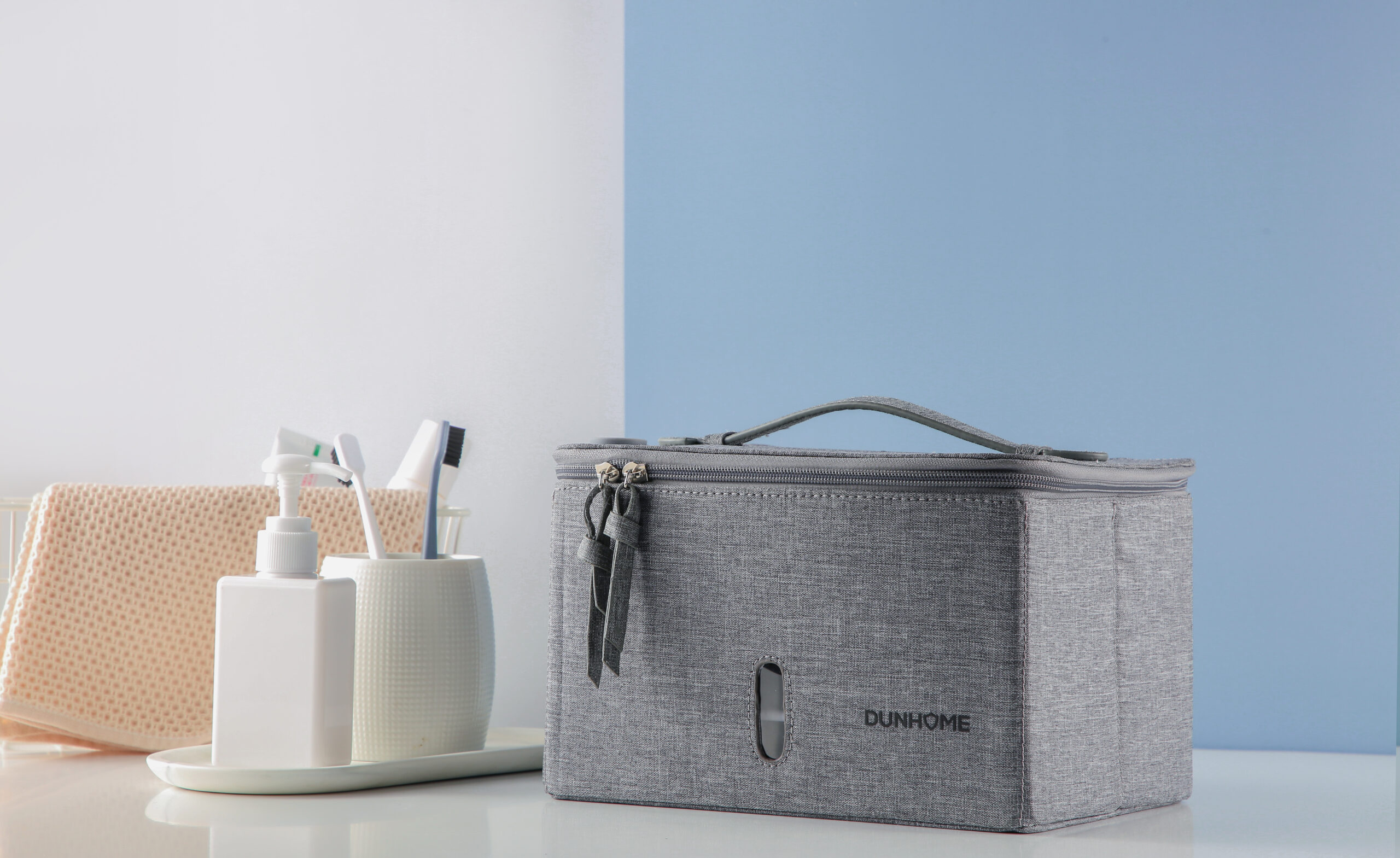 Gray foldable UV disinfection bag displayed with toiletries