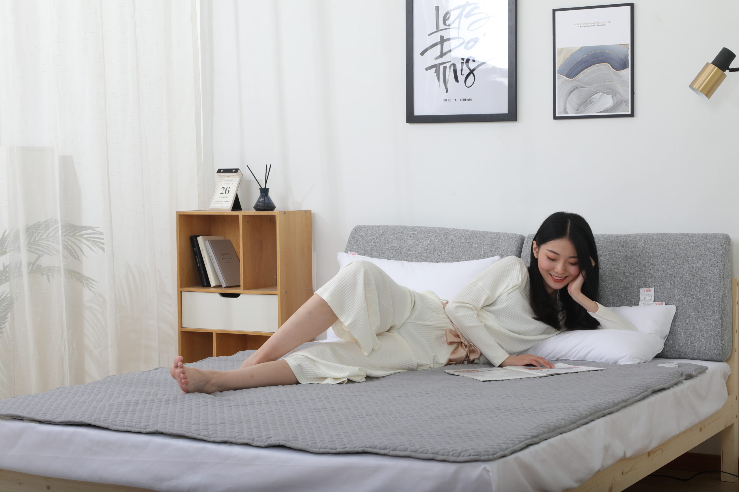 W20 Graphene Low-Voltage Smart Heated Blanket: woman reading while reclining in bed.