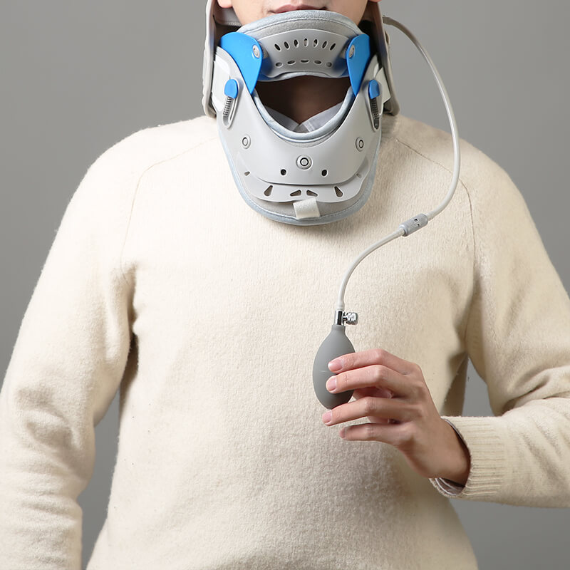 Woman holding the neck brace controller while wearing it