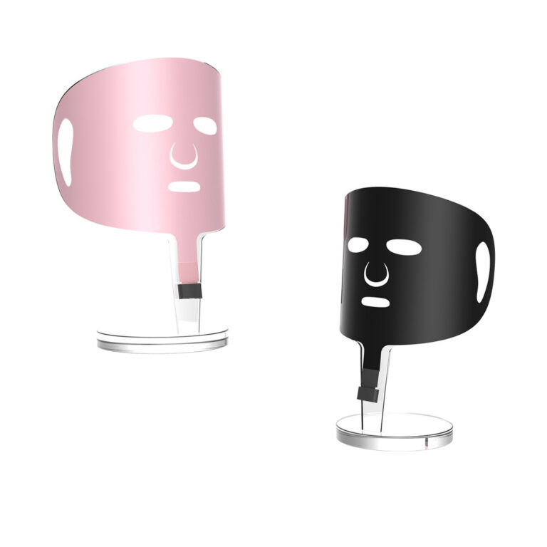 X10 Graphene Heated Face Mask: pink and black masks on display stands.