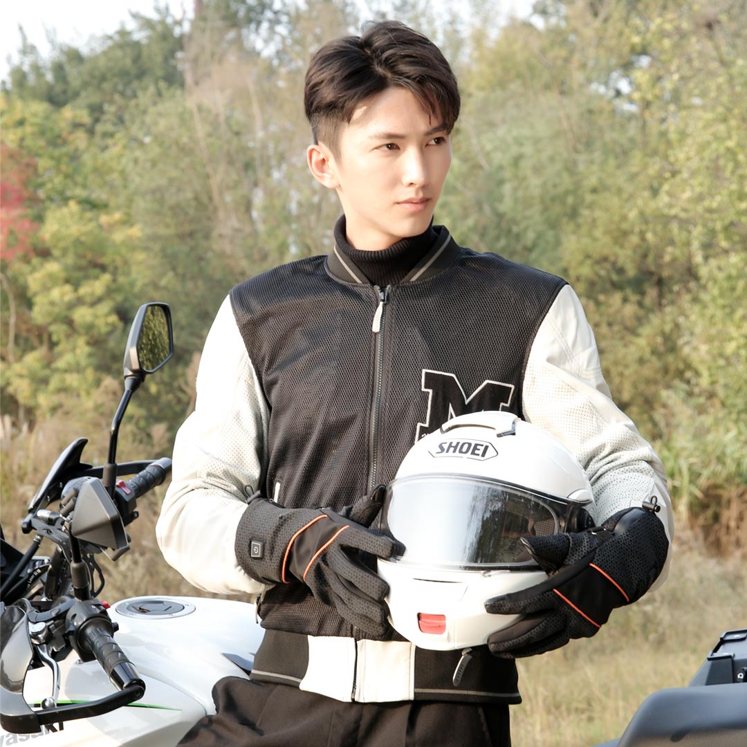 X20 Electric Heated Gloves: man wearing gloves beside a motorcycle.