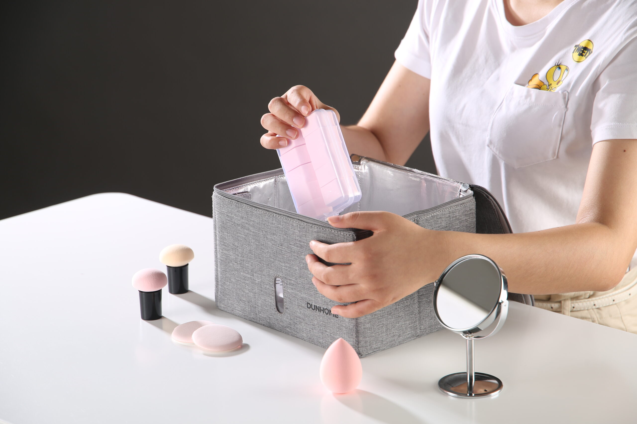 Gray foldable UV disinfection bag holding personal items