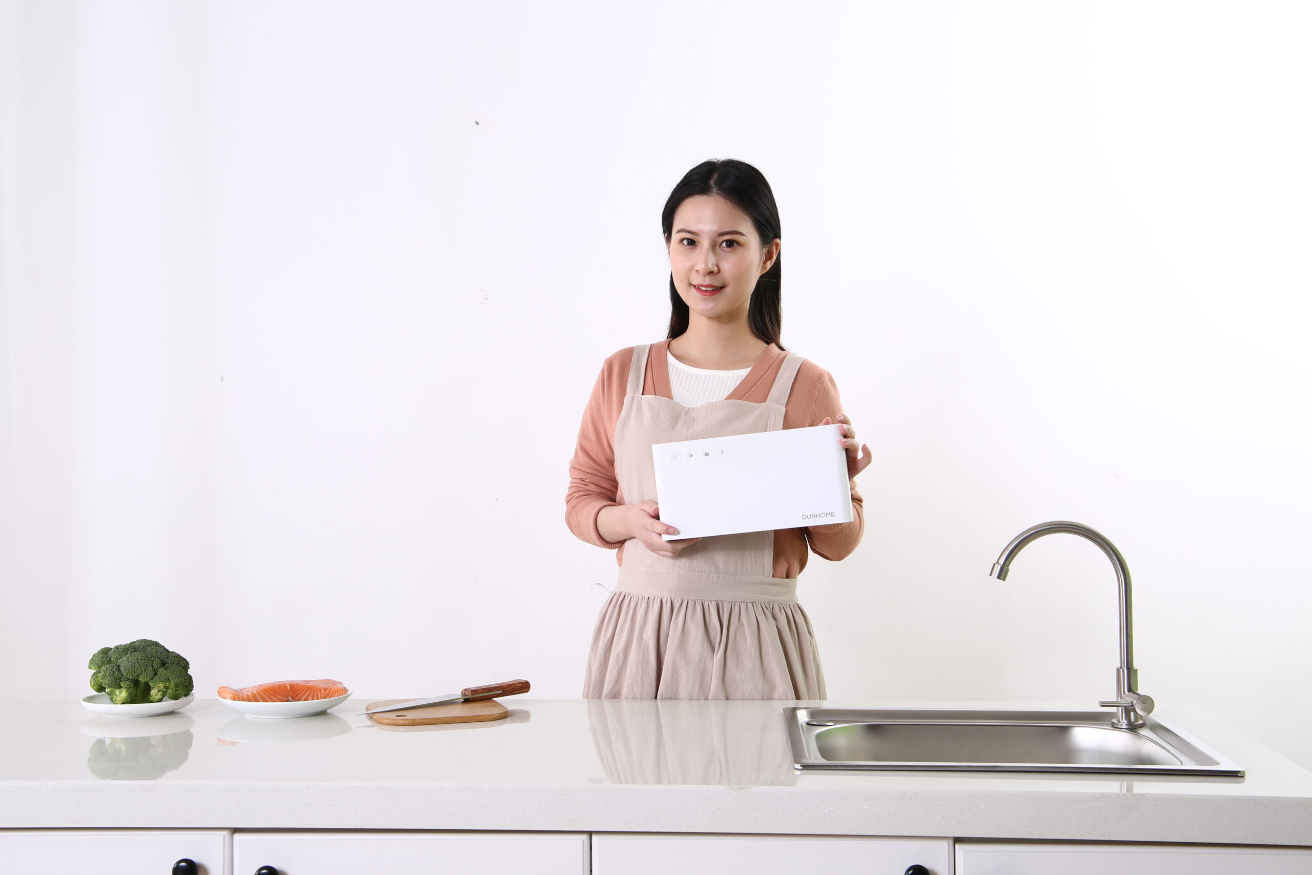 Food purification device held beside a kitchen sink