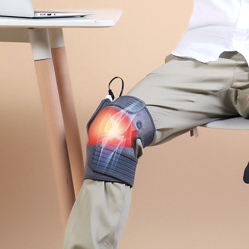 K30 Graphene Heated Knee Pad: close-up of the pad worn over trousers.