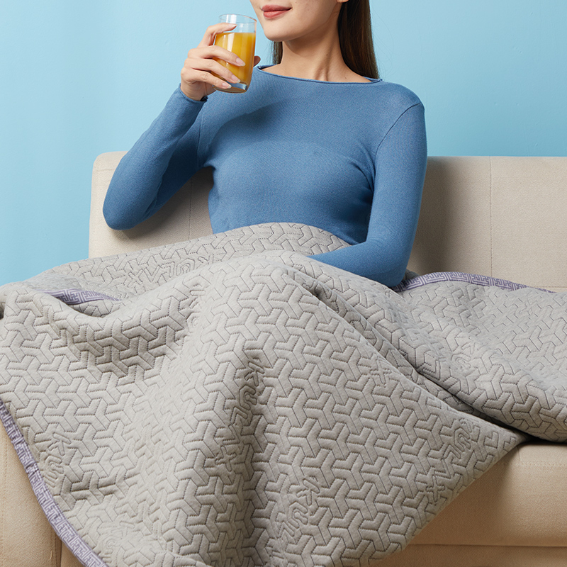 Graphene Electric Blanket: blanket used across the lap on a sofa.