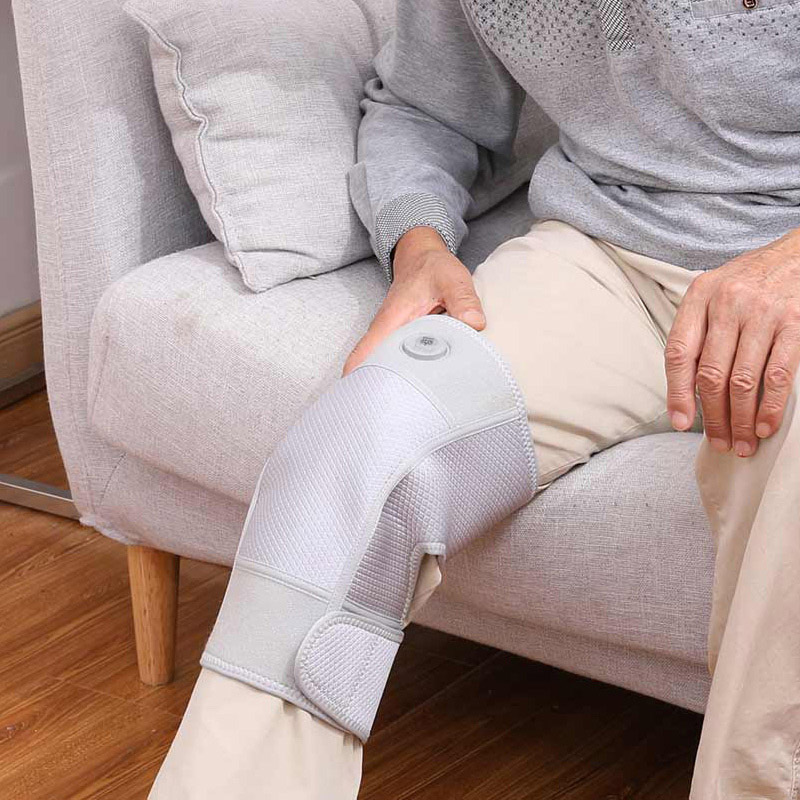 G10 Graphene Far-Infrared Heated Knee Pad: older man wearing the pad while seated.