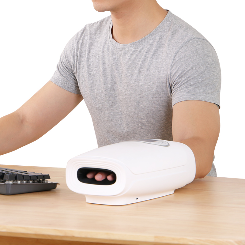 Hand Massager: man using the massager at a desk.