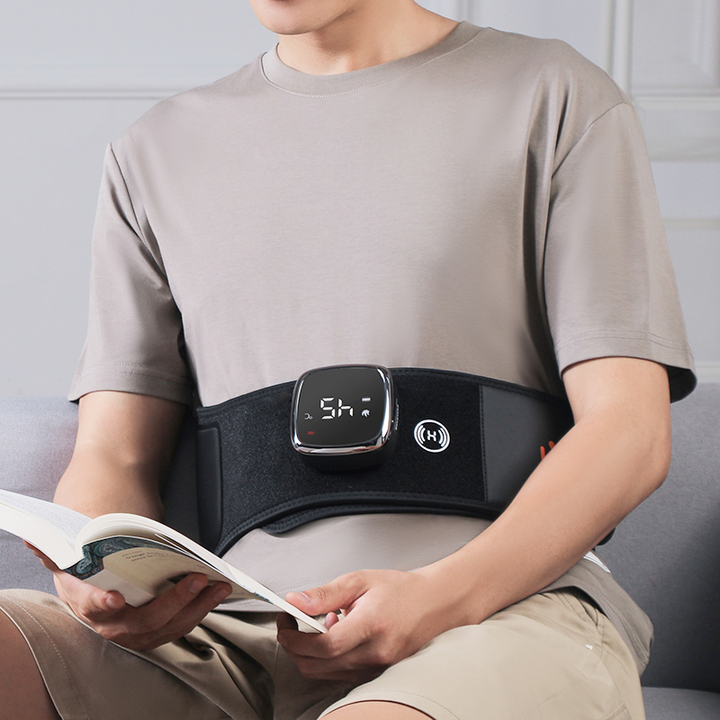Graphene Heated Massage Belt: belt worn while reading on a sofa.