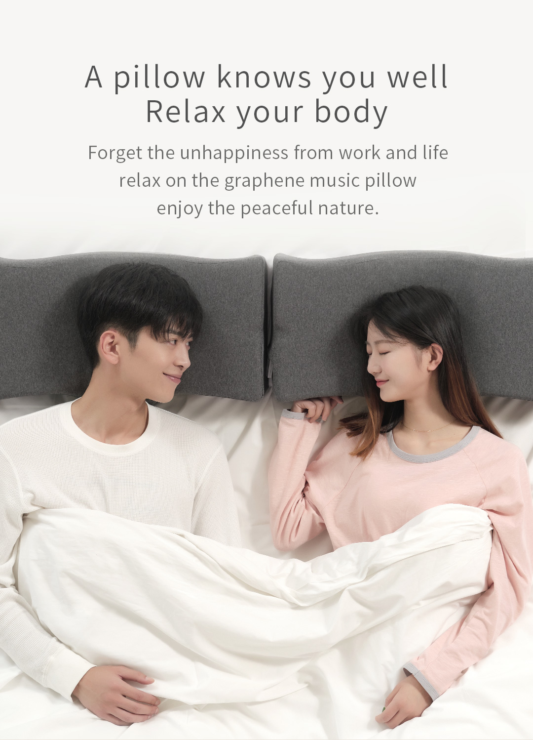 U10 Graphene Heated Smart Sleep Pillow: couple sitting in bed with contoured pillows.