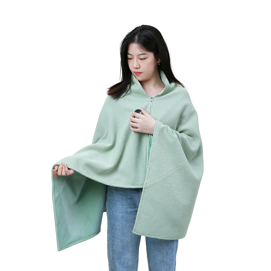 Woman standing while wearing the mint heated shawl