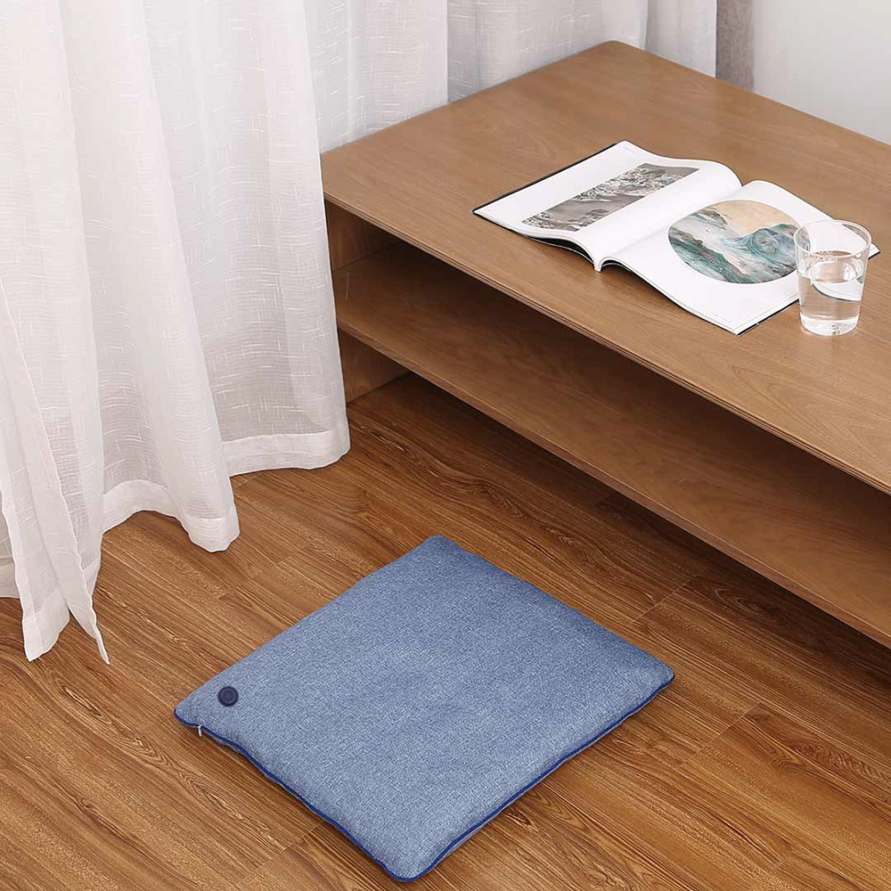 M10 seat cushion placed on the floor beside a low table